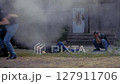 Injured men flee street fight scene at night in cloud of smoke, slow motion 127911706