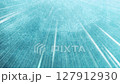Light streaks and radial lines on a textured blue-green background 127912930