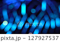 Blue bokeh background video. Illumination and the silhouette of a walking person. 127927537