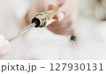 Mascara, makeup concept. Female hand takes out eyelash brush. Close-up 127930131