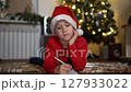young boy toddler writing a letter to santa. Christmas letter santa red hat 127933022