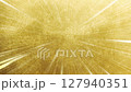 Strong streaks of light on a textured gold background, radial lines 127940351