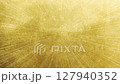 Weak streaks of light on a textured gold background Radial lines 127940352