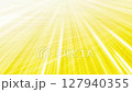 Light streaks on yellow light background, thin intersecting light glow lines 127940355