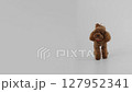 An Adorable Cute Brown Dog Figurine Displayed on a Simple Minimalist Background, Captivating 127952341