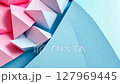 Pink and blue abstract geometric shapes are rotating slowly on a light blue background 127969445