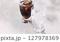 Cool iced coffee poured into a glass 127978369