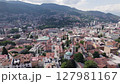 Capital city of Sarajevo in mountainous hilly terrain. Aerial trucking	 127981167