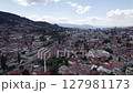 Aerial: Sarajevo cityscape with river, historic buildings, and hills	 127981173