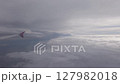 Cloud in sky. Airplane flight in white cloud at sky. Fly in soft clouds, looking from air plane window 127982018