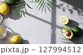 A cozy backdrop with fresh fruits and grass on a table with natural sunlight and shadows. 127994512