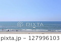 The seaside scenery, with the ocean stretching to the horizon and the waves constantly lapping and retreating, evokes the image of a relaxed, slow life. 127996103
