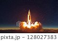 Rocket launch at dawn from a remote desert location showcasing powerful ascent into the night sky 128027383