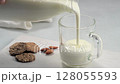 Pouring kefir and whole grain bread and almonds. 128055593