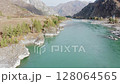 Aerial shot flying a river flowing in mountains. Amazing azure blue river, dynamic drone shot. Beautiful mountain river and evergreen trees in sunny autumn day. Breathtaking views 128064565