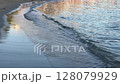 Gentle Waves Lapping on Sandy Shoreline at Sunset 128079929