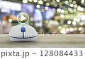 Play button with wireless computer mouse on wooden table over blur light and shadow of shopping mall, Business music online concept 128084433