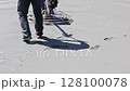 Workers are operating equipment to smooth freshly poured concrete slab finishing at construction site during works day 128100078