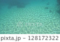 Light patterns spreading across the bottom of the water 128172322