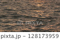 Sunset over calm sea waters 128173959
