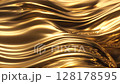 The golden liquid flows slowly in a dynamic manner. The liquid forms graceful waves, twists and soft curves in mid-air, moving with natural grace and energy 128178595