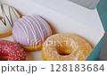 Donuts with colorful icing glazed designs on a white background. 128183684