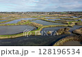 Drone flying over the slat marshes, view of Guerande on the horizon, France, 4k 128196534