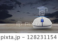 e-learning flat icon on wireless computer mouse on wooden table over sunset sky, Business study online concept 128231154