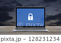 Padlock flat icon on modern laptop computer monitor screen on wooden table over sunset sky, Technology internet cyber security and safety online concept 128231234