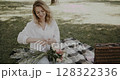 woman decorates bouquet as gift. Floristry creating flower 128322336