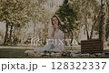 woman decorates bouquet as gift. Floristry creating flower 128322337