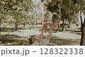 young beautiful woman holds bouquet of fresh flowers and enjoying 128322338