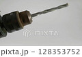 This is a detailed closeup view of a Drill Bit that is currently in action during use 128353752