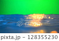 golden sun and ocean on a green screen background - ai generated 128355230