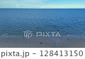 People walking at the beach 128413150