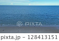 Quiet shoreline with clear water and open sky 128413151