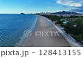 Empty sandy beach and bright blue tropical water 128413155