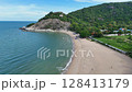 Forested rock formation and ocean from aerial perspective 128413179