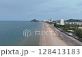 Urban beachfront under cloudy sky 128413183