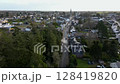 Drone is flying along the street of Missillac commune towards a church, 4k 128419820