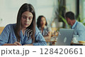 Female employee prepares pitch with laptop and notebook during lunch break in close up slow motion pan  128420661