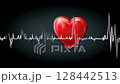Heartbeat monitor displaying a vibrant red heart against a dark background 128442513