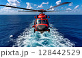 Helicopter flies over calm ocean waters on a bright sunny day with scattered clouds 128442529