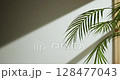 Soft sunlight through wooden windows, shadows, green leaves and texture of white walls. 128477043