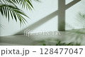 Soft sunlight through wooden windows, shadows, green leaves and texture of white walls. 128477047