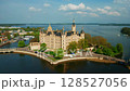 Aerial view of historic Schwerin Castle in northern Germany, beautifully located on an island surrounded by lakes and lush parkland. Popular tourist destination and architectural gem 128527056