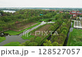 Fly above Schwerin Castle surroundings, highlighting the intricate gardens, reflective lakes, and historic architecture. Perfect for cinematic storytelling. 128527057