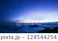 The moon setting in the sea of clouds 128544254