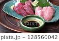Fatty tuna sashimi dipped in soy sauce 128560042