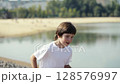 A Child is Joyfully Running Alongside the Waters Edge, Embracing Nature and Freedom 128576997
